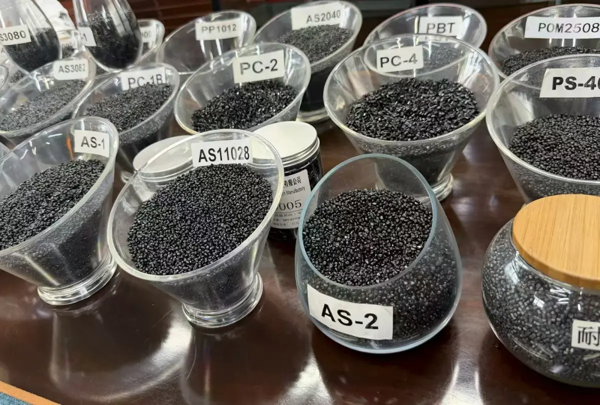 Black masterbatch grades shown in sample containers